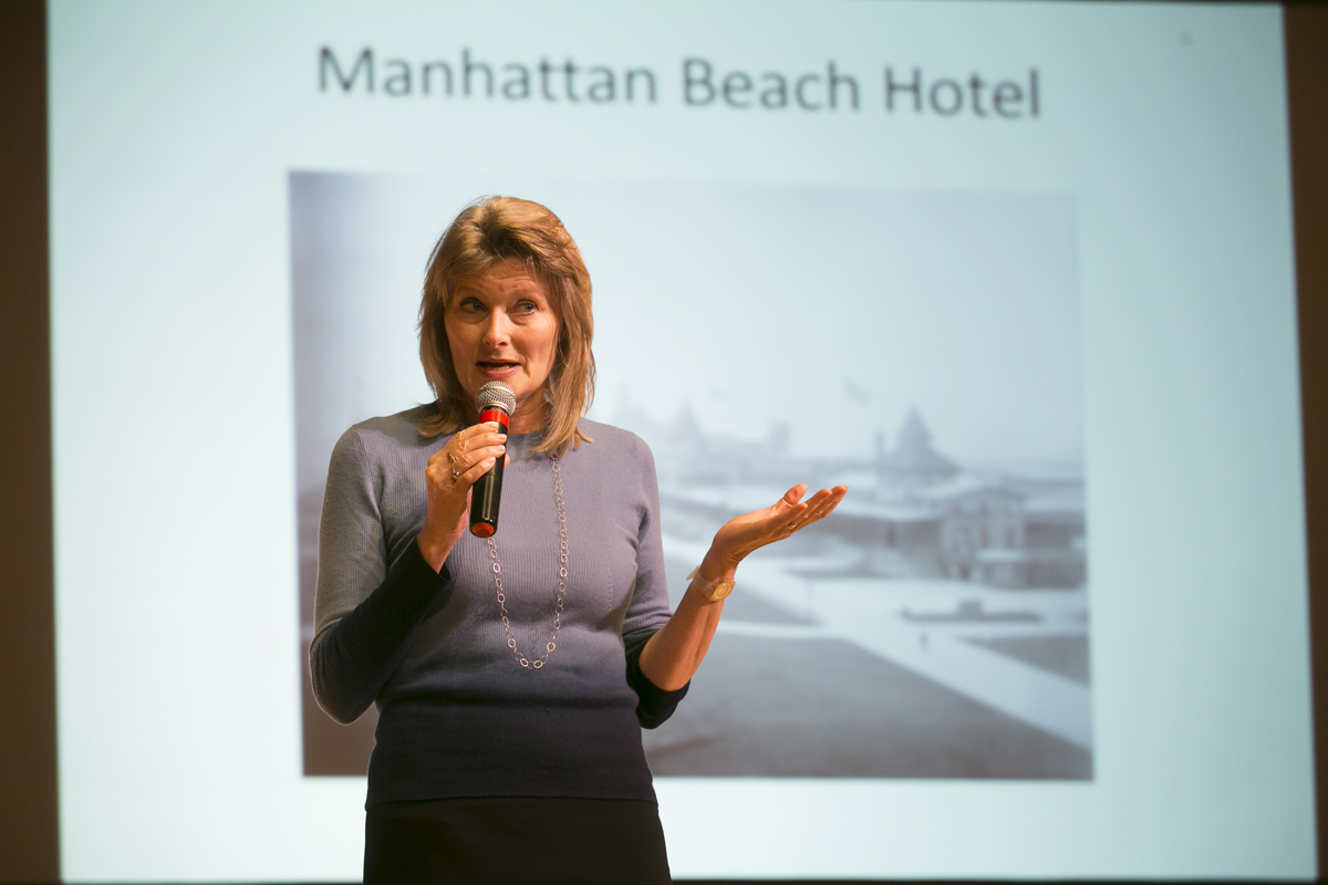 Jennifer Egan standing with a microphone in her hand
