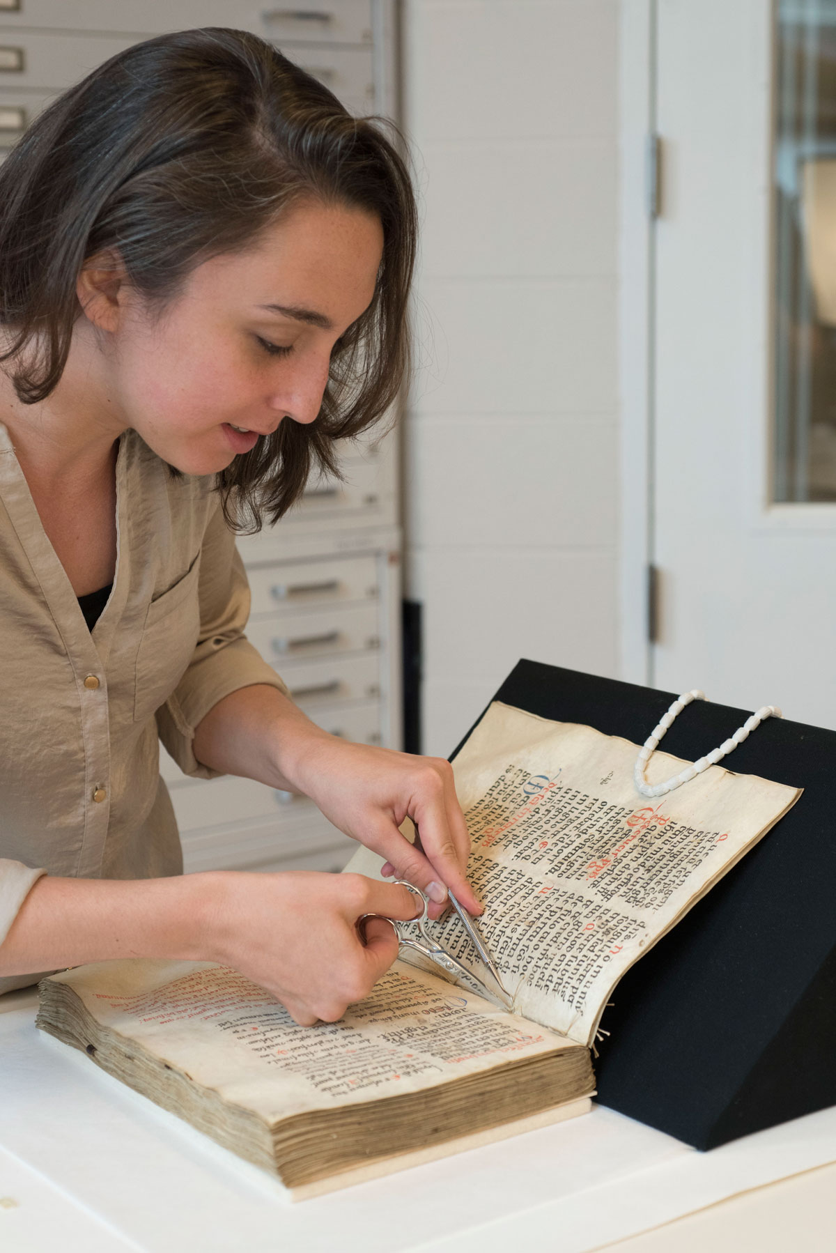 Catherine Magee doing preservation work on a book