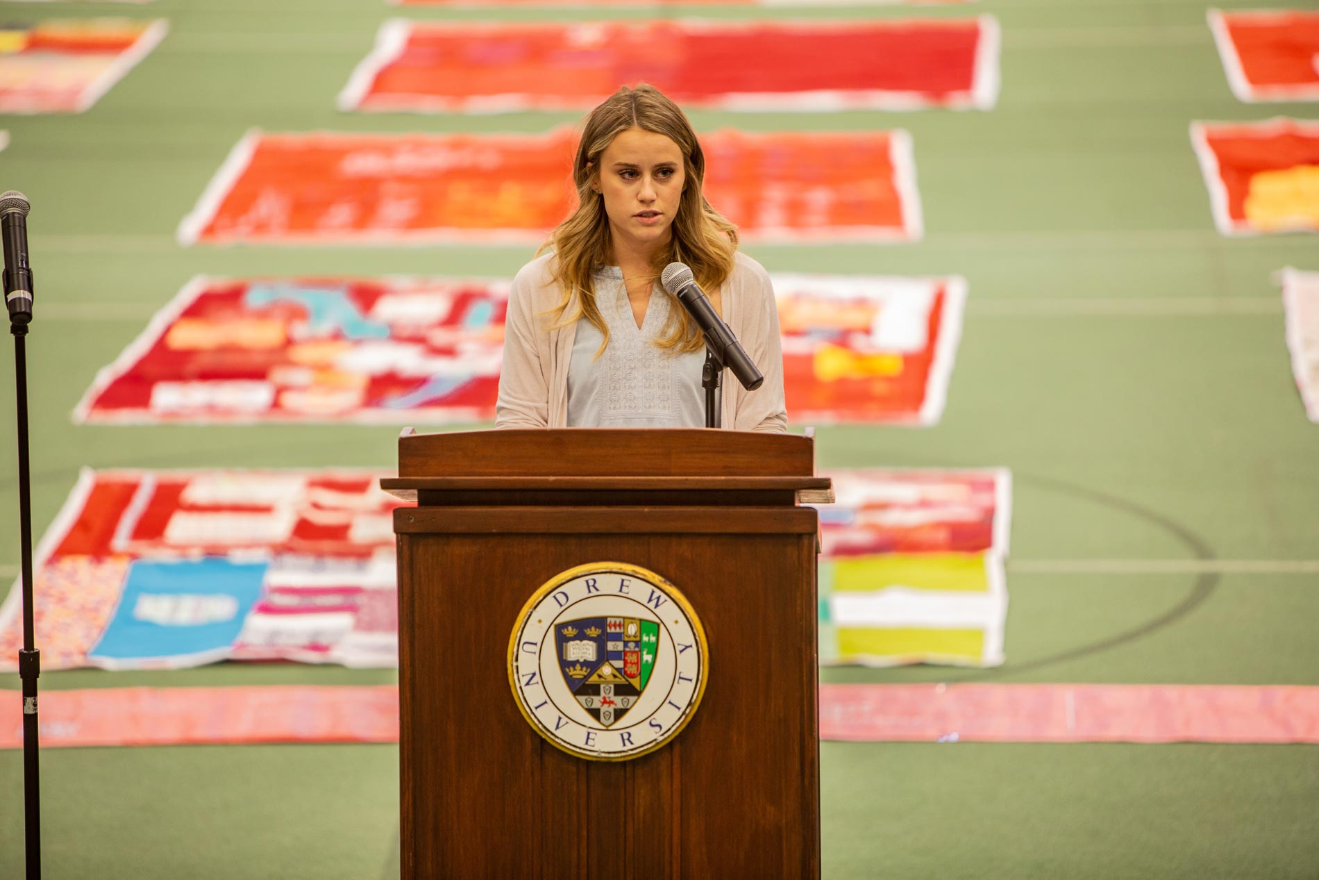 Samantha Savidge speaking behind a lectern