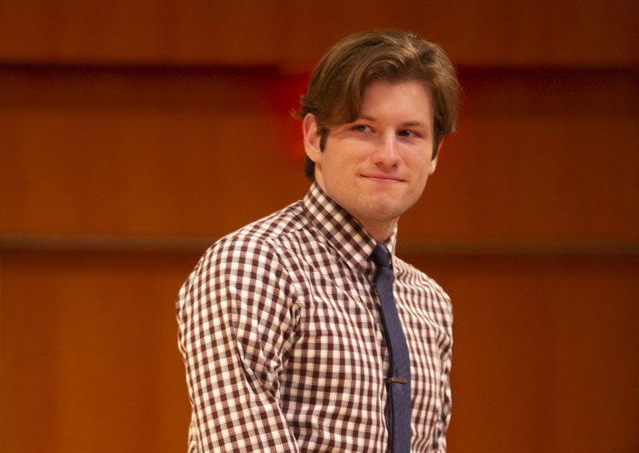 John Rinald standing on stage