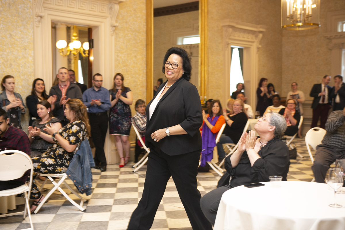 Brenda Hall smiling as she walks up to receive an award