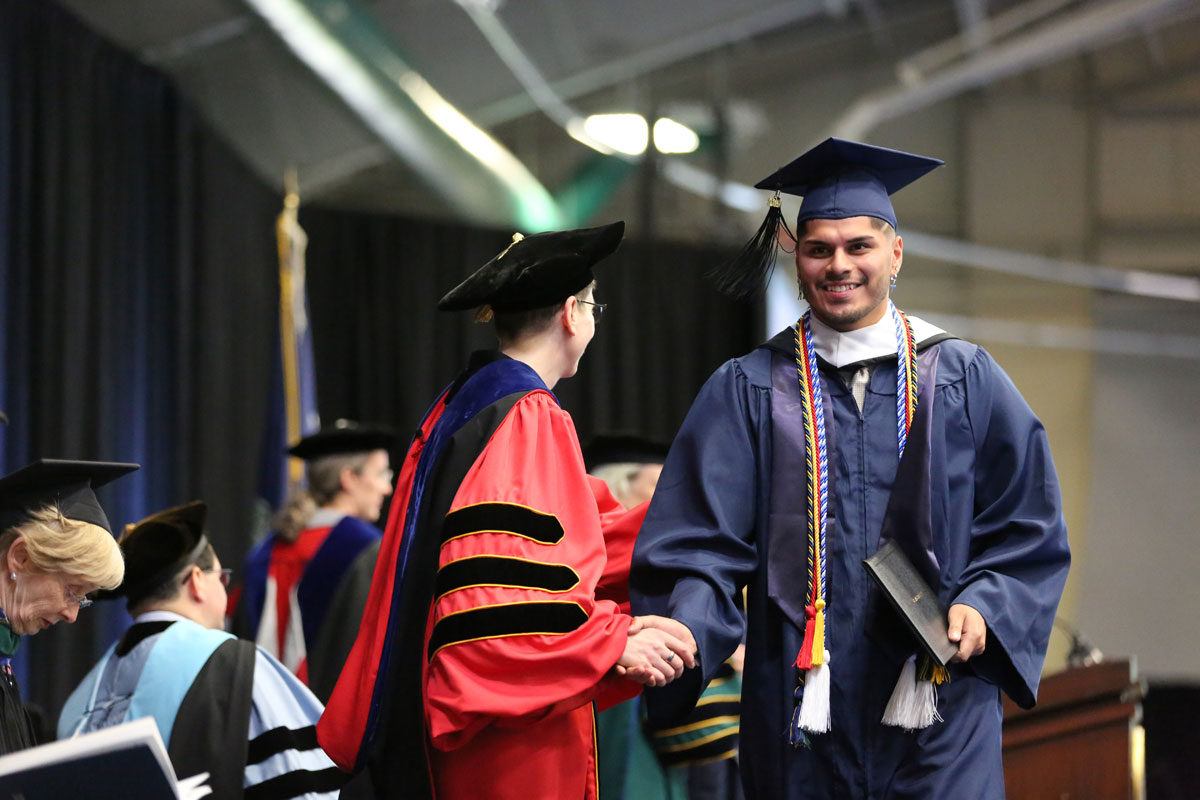 Male graduate shaking hands with Provost Debra Liebowitz