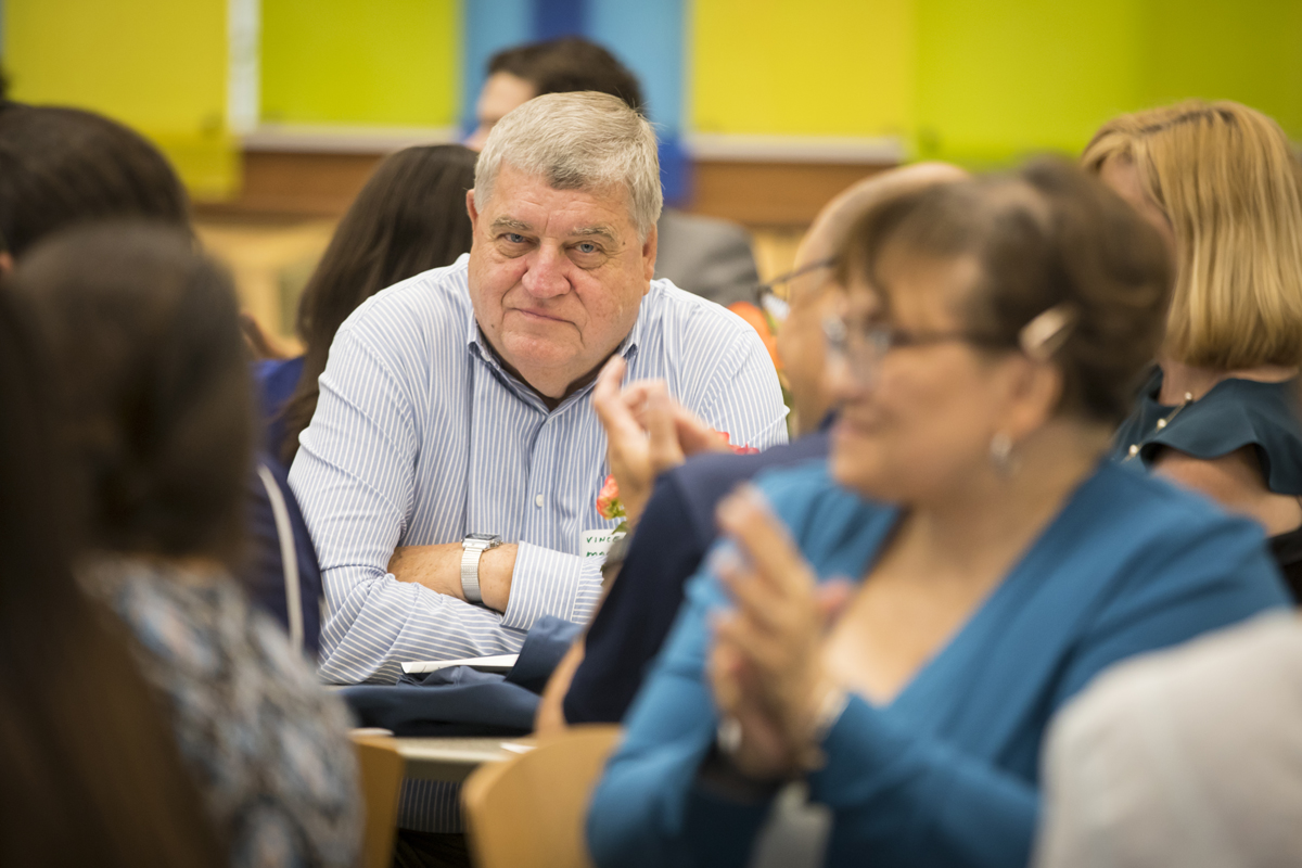 Vincent Masco seated at a table and smiling
