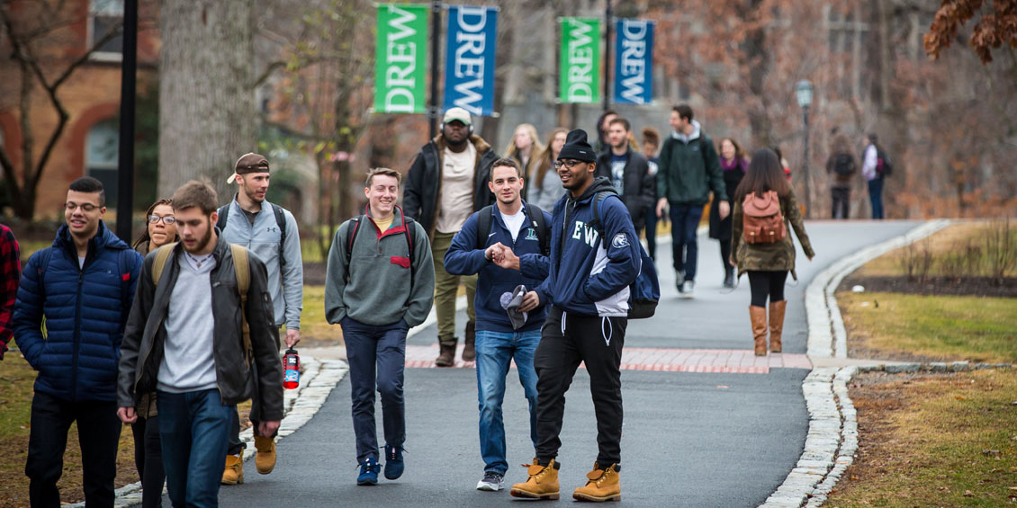 Drew students walking and talking on a path